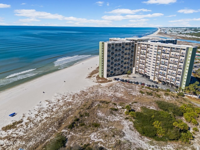 drone / aerial view featuring a water view and a view of the beach