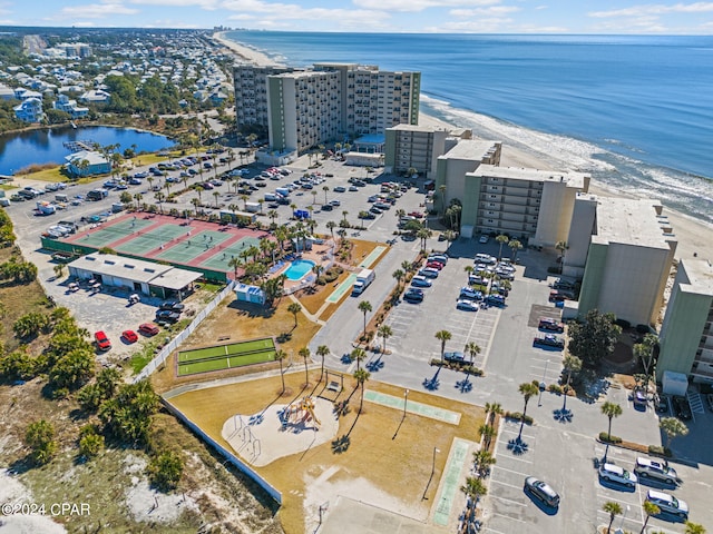 drone / aerial view featuring a water view and a view of the beach