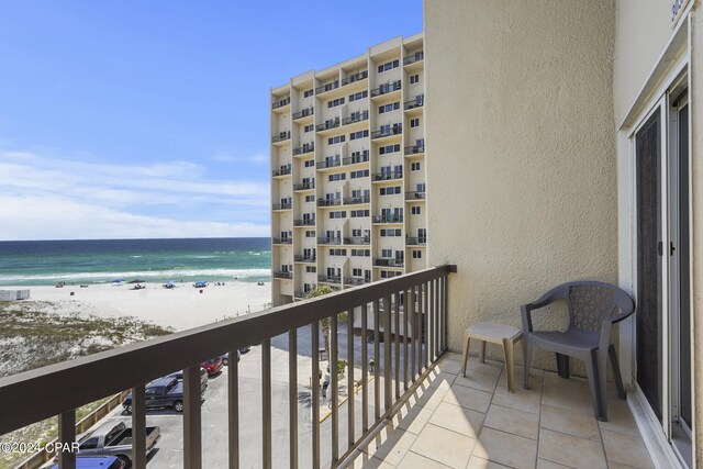 balcony featuring a water view and a view of the beach