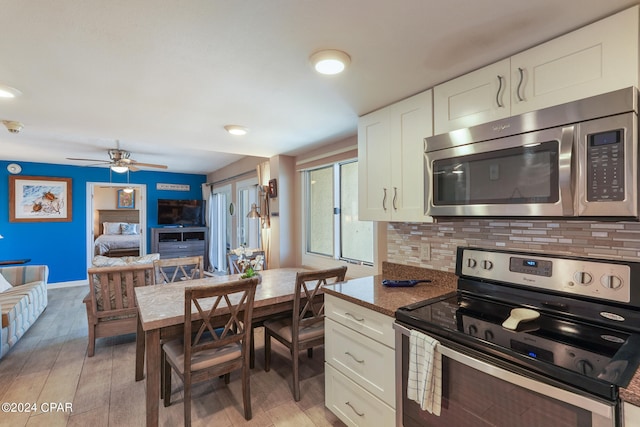 kitchen with ceiling fan, stainless steel appliances, light hardwood / wood-style floors, tasteful backsplash, and white cabinets