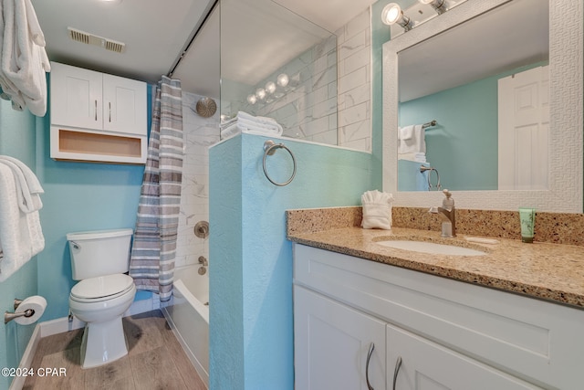 full bathroom with shower / bath combo, oversized vanity, hardwood / wood-style flooring, and toilet