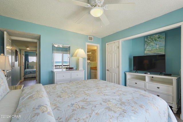 bedroom with hardwood / wood-style flooring, a closet, ceiling fan, and a textured ceiling