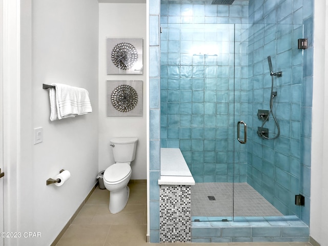 bathroom featuring tile patterned flooring, an enclosed shower, and toilet