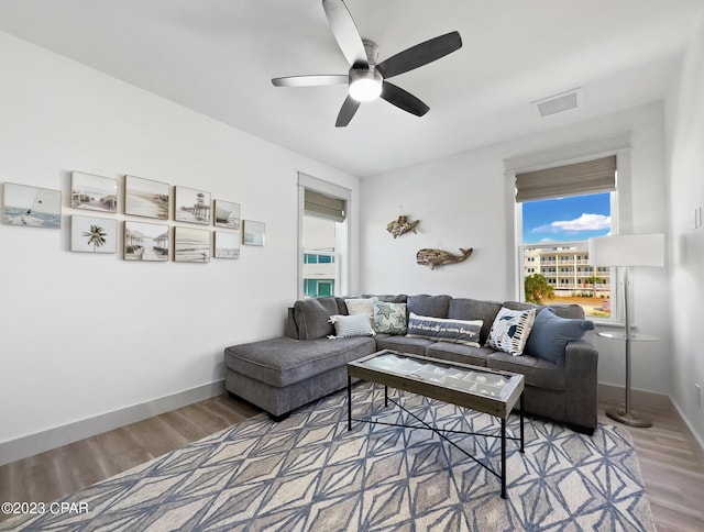 living room featuring hardwood / wood-style flooring and ceiling fan