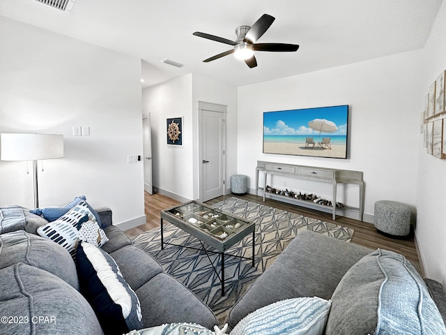 living room featuring hardwood / wood-style flooring and ceiling fan