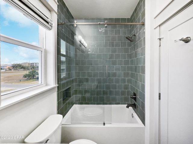 bathroom with enclosed tub / shower combo and toilet