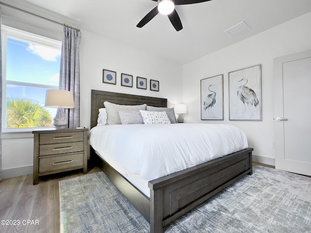 bedroom featuring light hardwood / wood-style floors and ceiling fan