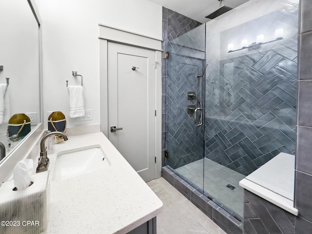 bathroom with walk in shower and vanity