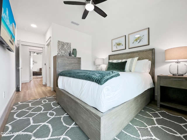 bedroom with hardwood / wood-style flooring and ceiling fan