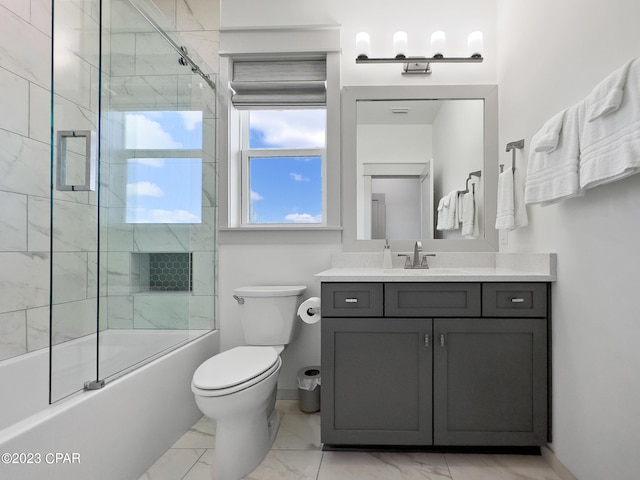 full bathroom with vanity, combined bath / shower with glass door, and toilet