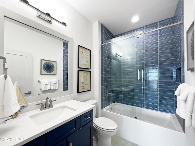 full bathroom featuring vanity, combined bath / shower with glass door, and toilet