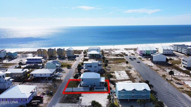 bird's eye view featuring a water view and a view of the beach