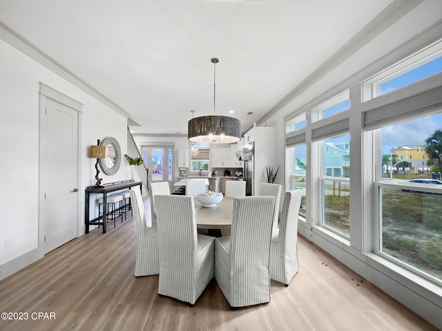 dining room featuring light hardwood / wood-style floors and a chandelier