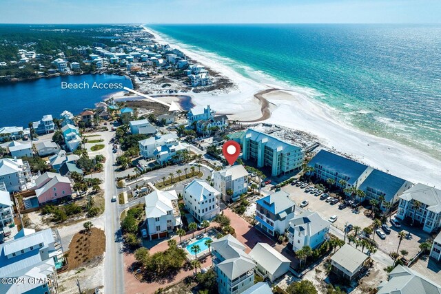 aerial view with a water view and a beach view