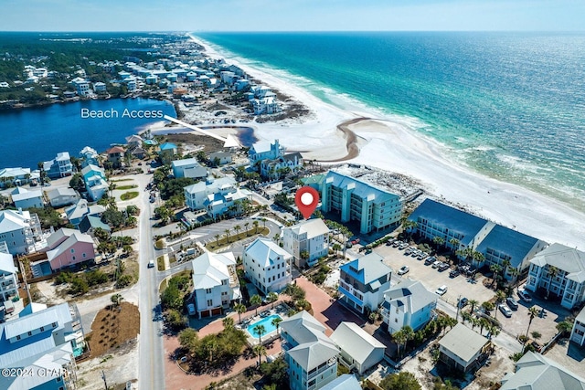 drone / aerial view featuring a water view and a view of the beach