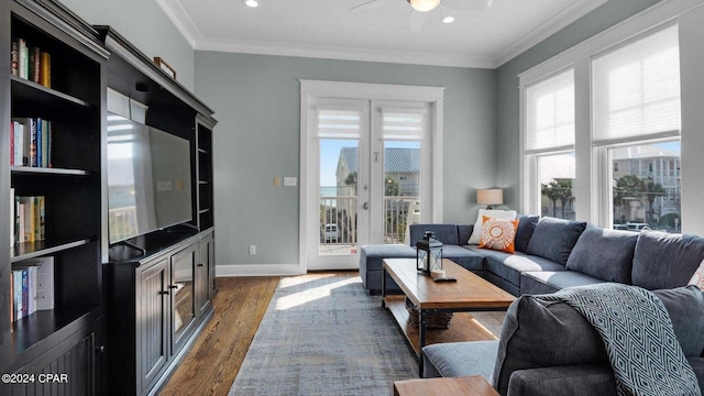 living room featuring crown molding, a healthy amount of sunlight, and dark hardwood / wood-style floors