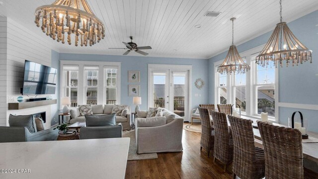 living room featuring dark hardwood / wood-style floors, wood ceiling, and a chandelier