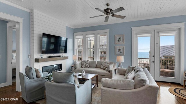 living room featuring wood-type flooring, ceiling fan, wood ceiling, and a fireplace