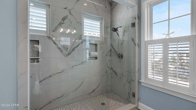 bathroom featuring a shower with door