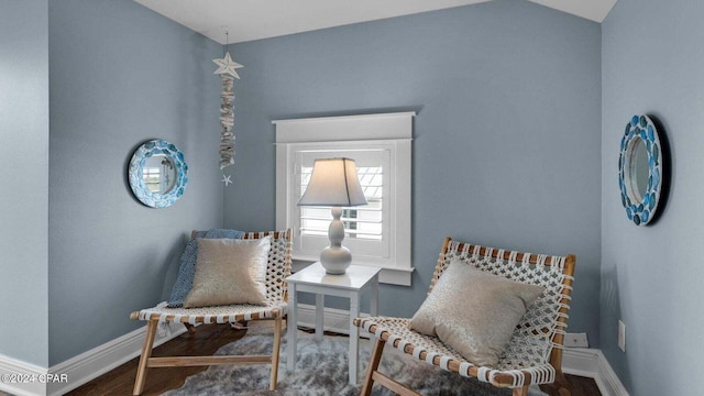 sitting room featuring vaulted ceiling and hardwood / wood-style floors