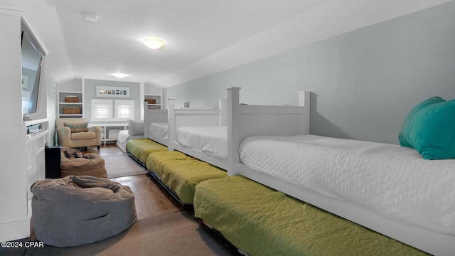 bedroom featuring hardwood / wood-style floors and vaulted ceiling