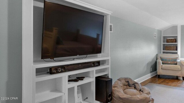 sitting room with hardwood / wood-style flooring and vaulted ceiling