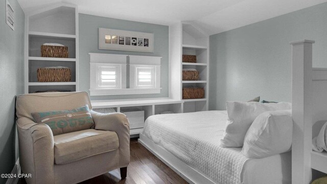 bedroom featuring lofted ceiling and dark wood-type flooring