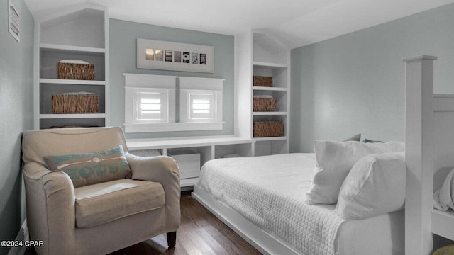 bedroom featuring lofted ceiling and dark hardwood / wood-style flooring