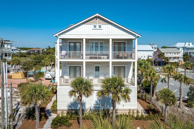 view of front of house featuring french doors and a balcony