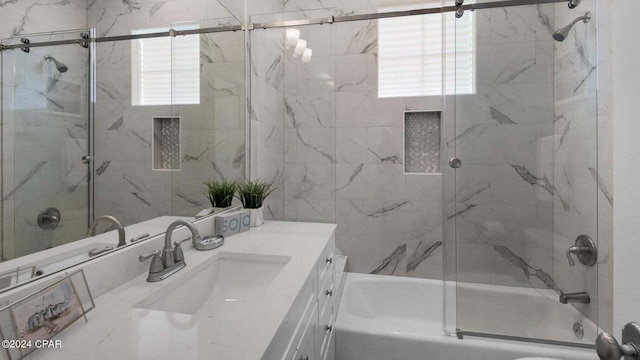 bathroom with vanity and combined bath / shower with glass door