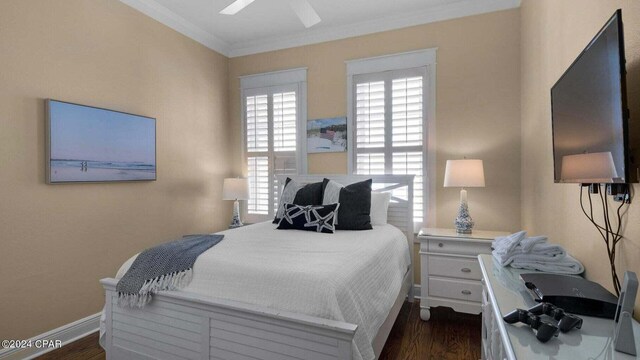 bedroom featuring crown molding, dark wood-type flooring, and ceiling fan