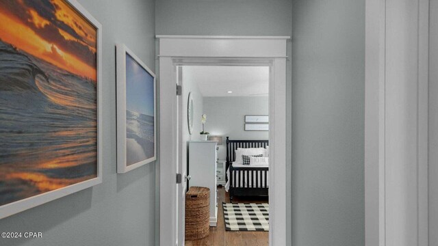 hallway with hardwood / wood-style floors