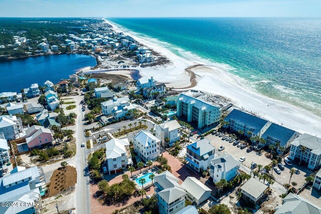 bird's eye view with a water view and a beach view