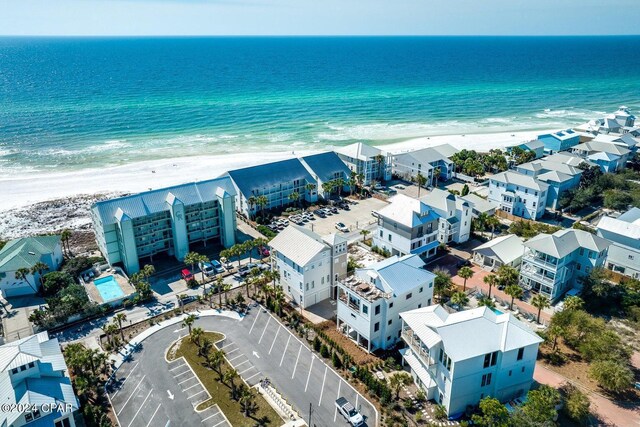 drone / aerial view featuring a beach view and a water view