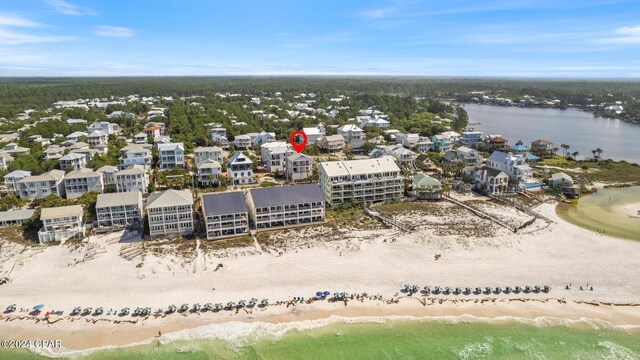 birds eye view of property with a beach view and a water view