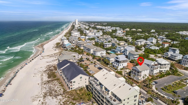 drone / aerial view with a water view and a beach view