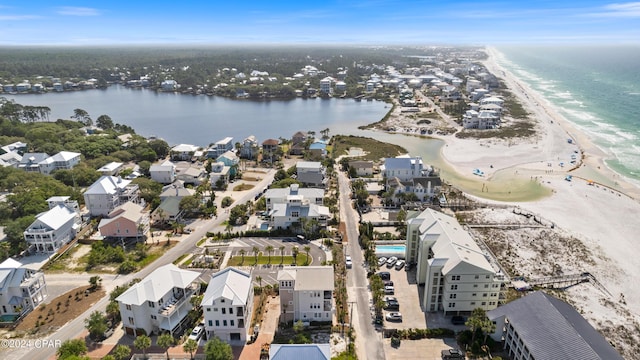 drone / aerial view featuring a water view and a view of the beach