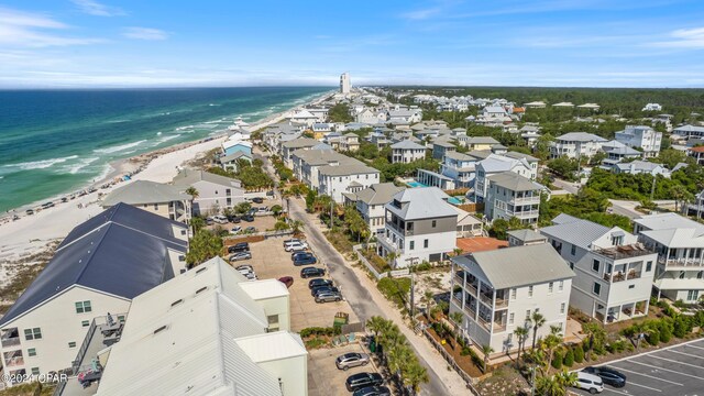 bird's eye view with a water view and a beach view