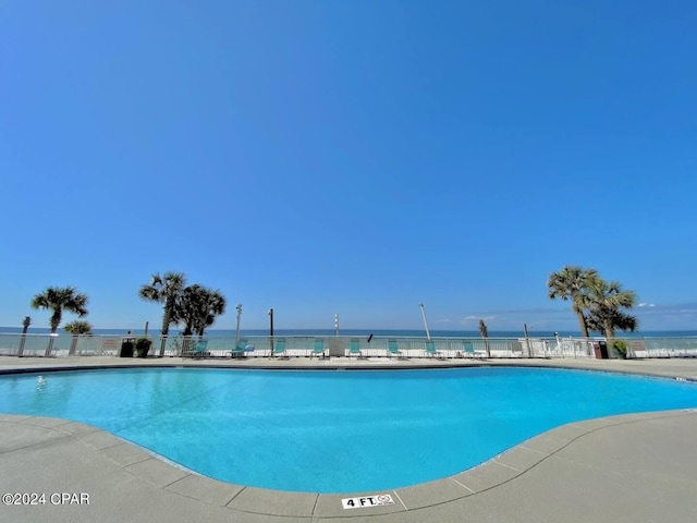 view of swimming pool featuring a water view