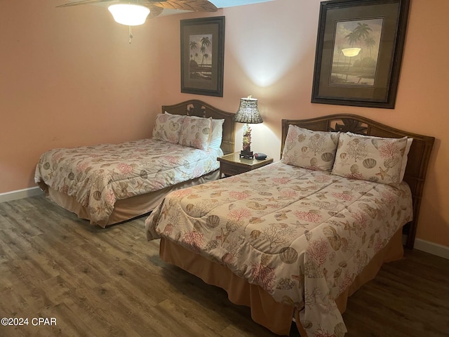 bedroom featuring ceiling fan and dark wood-type flooring