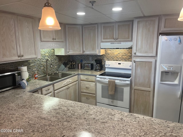 kitchen featuring backsplash, sink, white appliances, and light brown cabinets