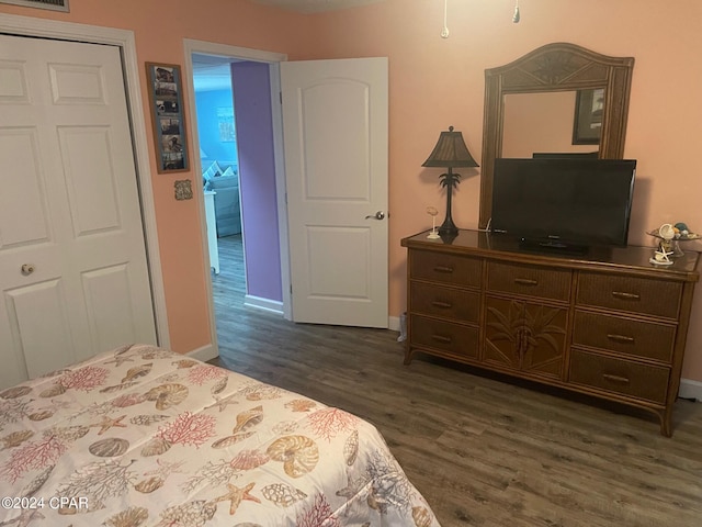 bedroom with dark hardwood / wood-style floors