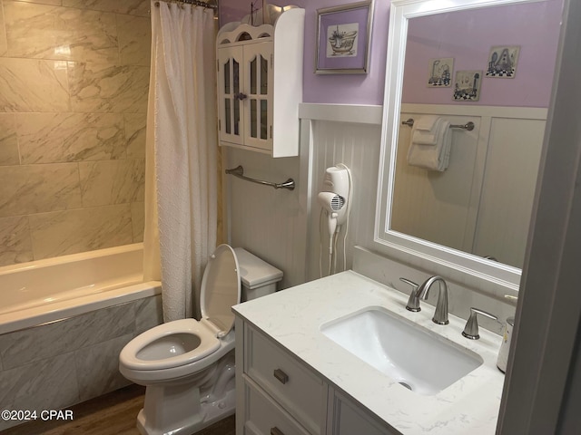 full bathroom featuring shower / bath combination with curtain, toilet, wood-type flooring, and vanity