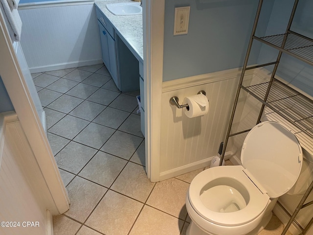 bathroom featuring tile patterned floors, vanity, and toilet