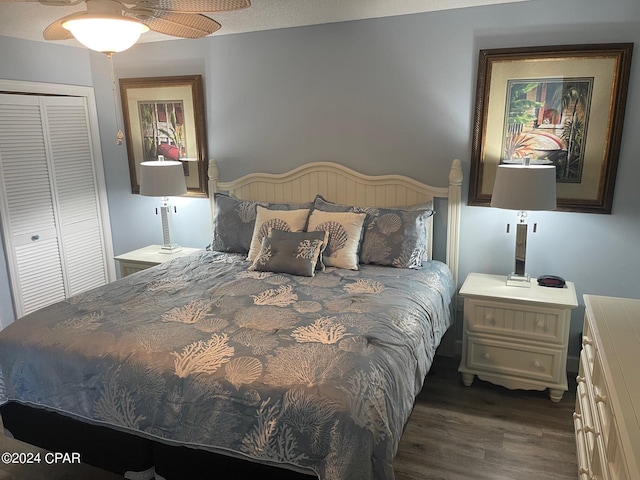 bedroom with dark hardwood / wood-style floors, a closet, and ceiling fan