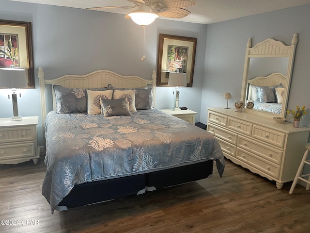 bedroom with ceiling fan and dark wood-type flooring