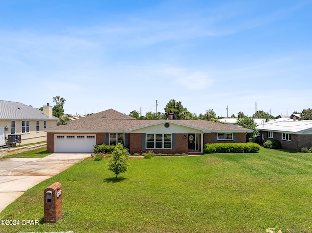 ranch-style house featuring a garage, a front yard, and central air condition unit