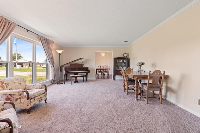 dining space with ornamental molding and carpet floors