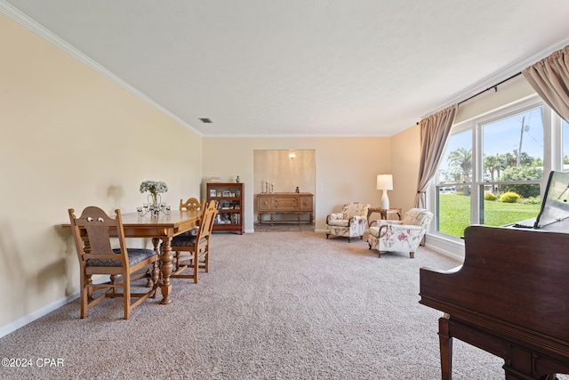 dining space featuring ornamental molding and carpet floors