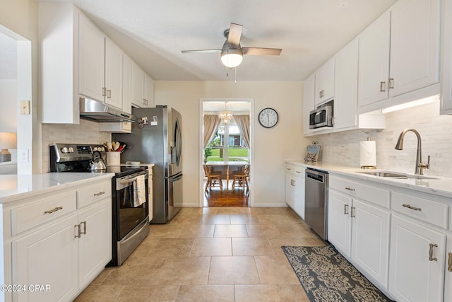 kitchen featuring sink, ceiling fan, backsplash, stainless steel appliances, and white cabinets